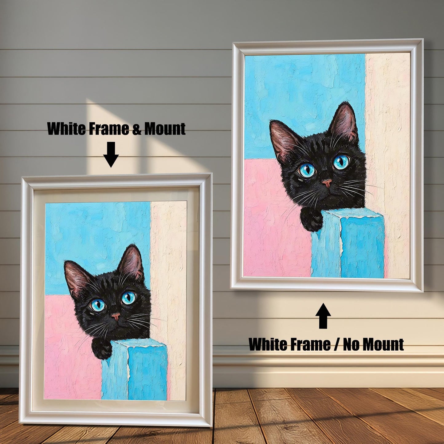 Two framed prints of a black cat with blue eyes on a wood paneled wall. One has a white frame with a mount, and the other is the same frame without a mount.