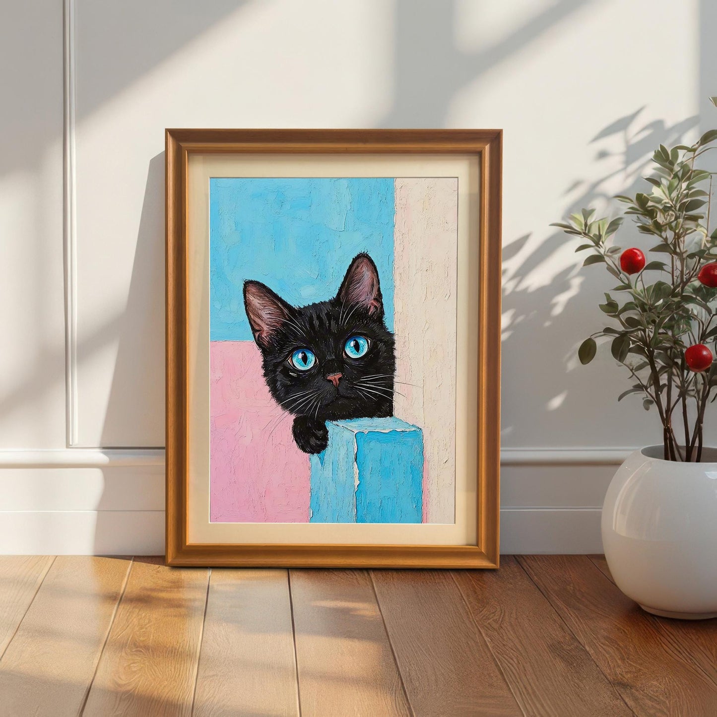 A framed print of a black cat with a golden orange frame leans against a white paneled wall next to a potted plant.