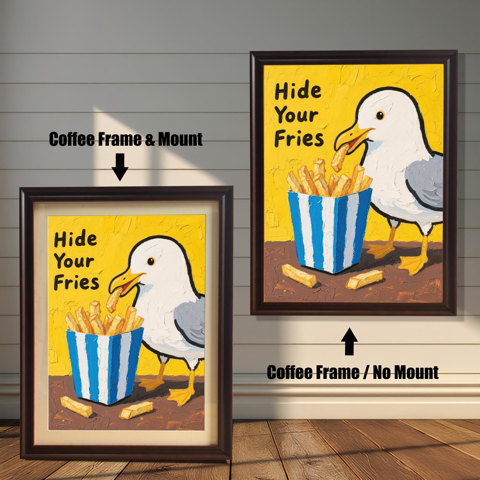 A side-by-side comparison of two framed prints of a seagull and fries. One has a coffee-colored frame with a mount, and the other has a coffee-colored frame without a mount.