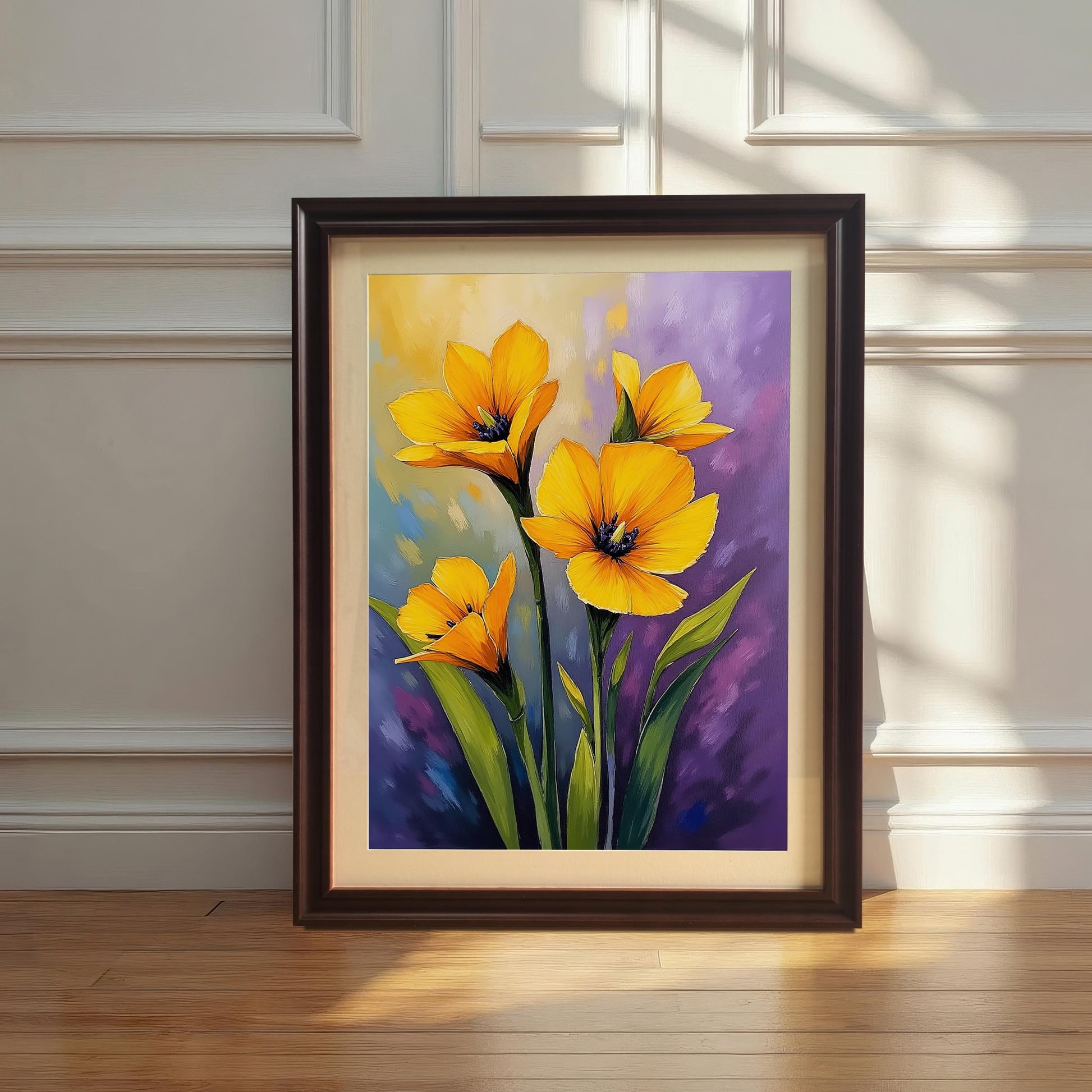 A framed print with a coffee-colored frame rests on a wooden floor against a white wainscoting wall, featuring a textured painting of yellow flowers on a purple and blue background.
