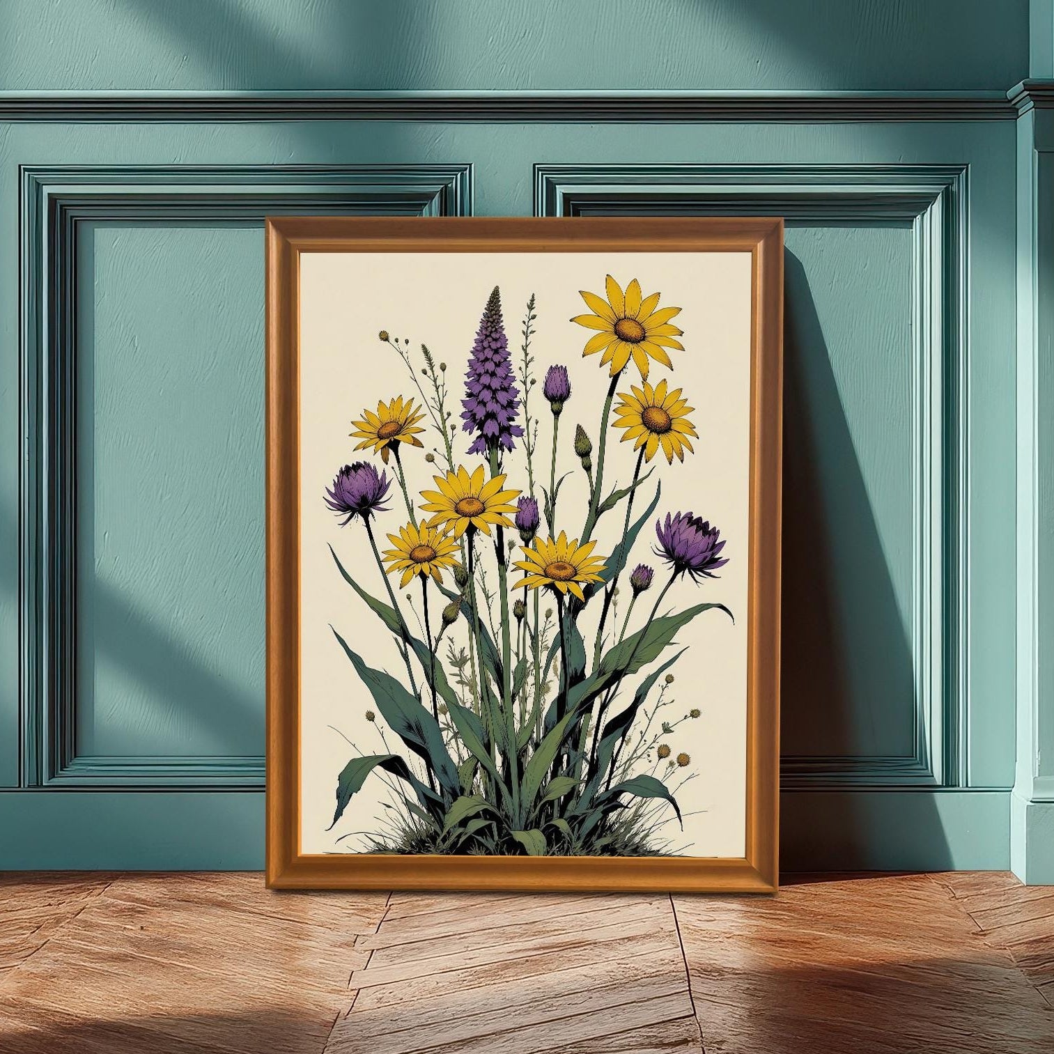 A framed print with an orange frame rests on a wooden floor against a teal-colored wainscoting wall, featuring a vibrant botanical illustration of yellow and purple flowers.