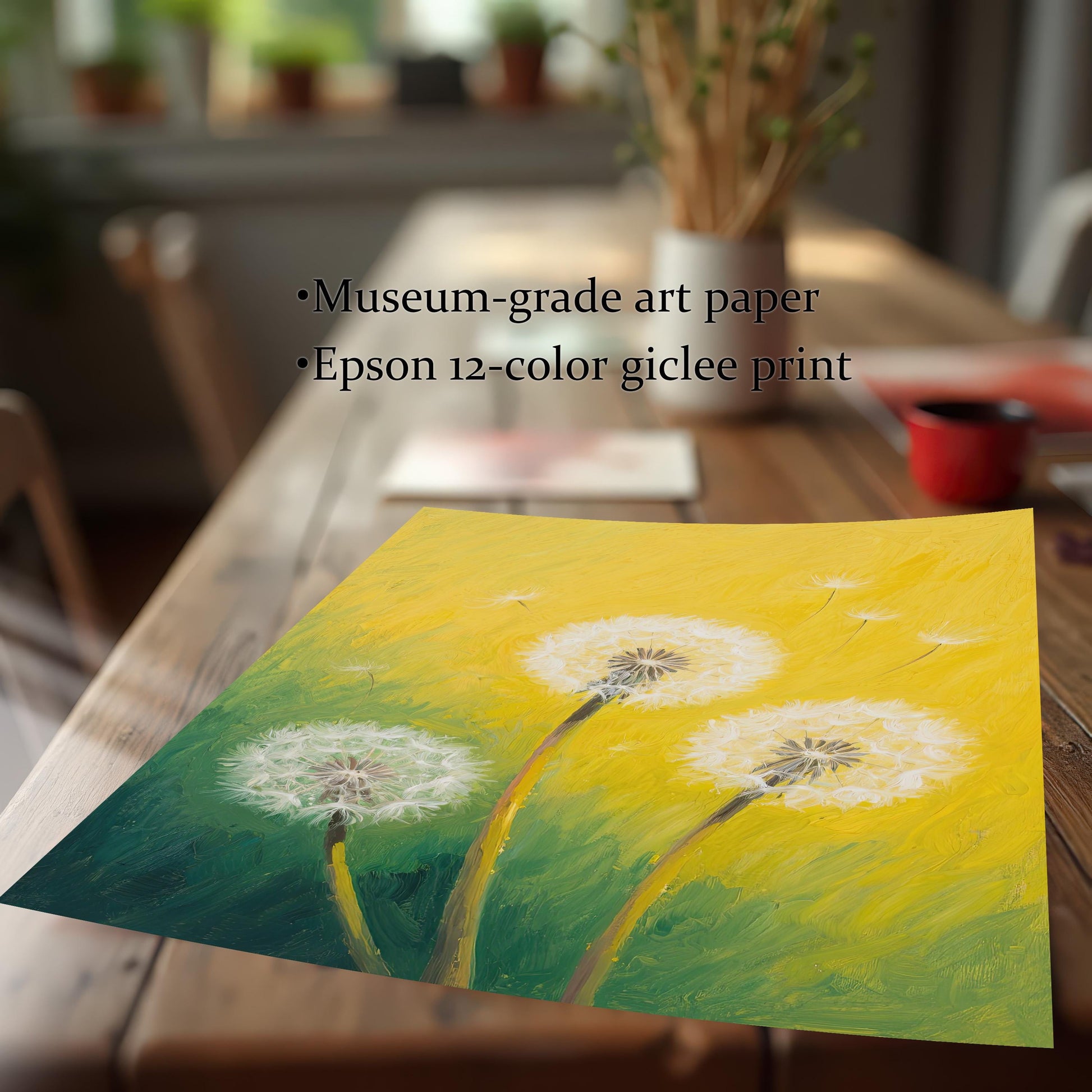 A close-up of the dandelion art print laying on a wooden table. Text lists "Museum-grade art paper" and "Epson 12-color giclee print."