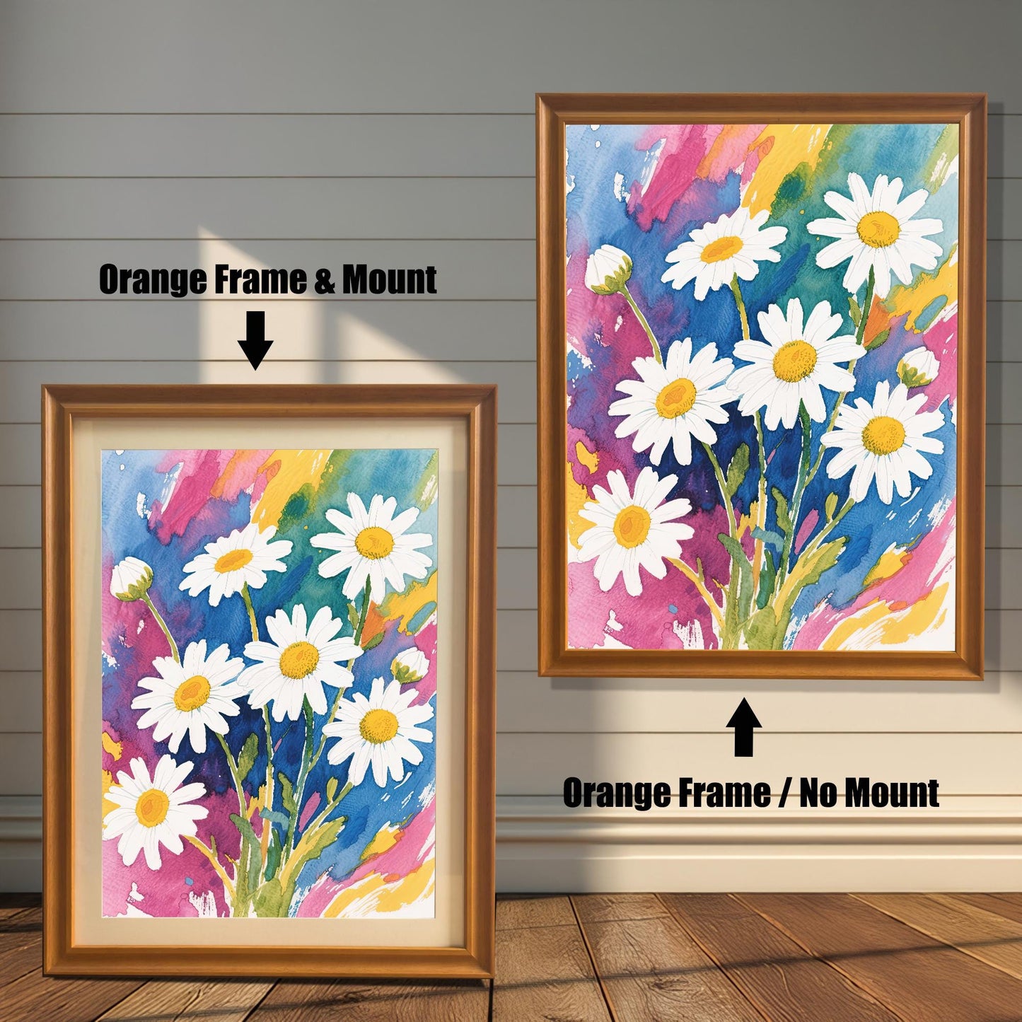 A side-by-side comparison of two framed daisy prints. The one on the left has an orange-colored frame and a cream-colored mat. The one on the right has an orange-colored frame with no mat.