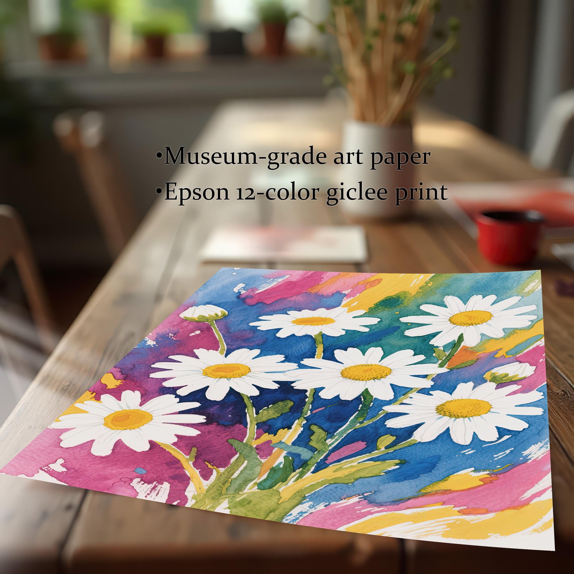 A close-up, angled view of an unframed watercolor print of white daisies lying on a wooden table, highlighting its museum-grade art paper and giclee printing.
