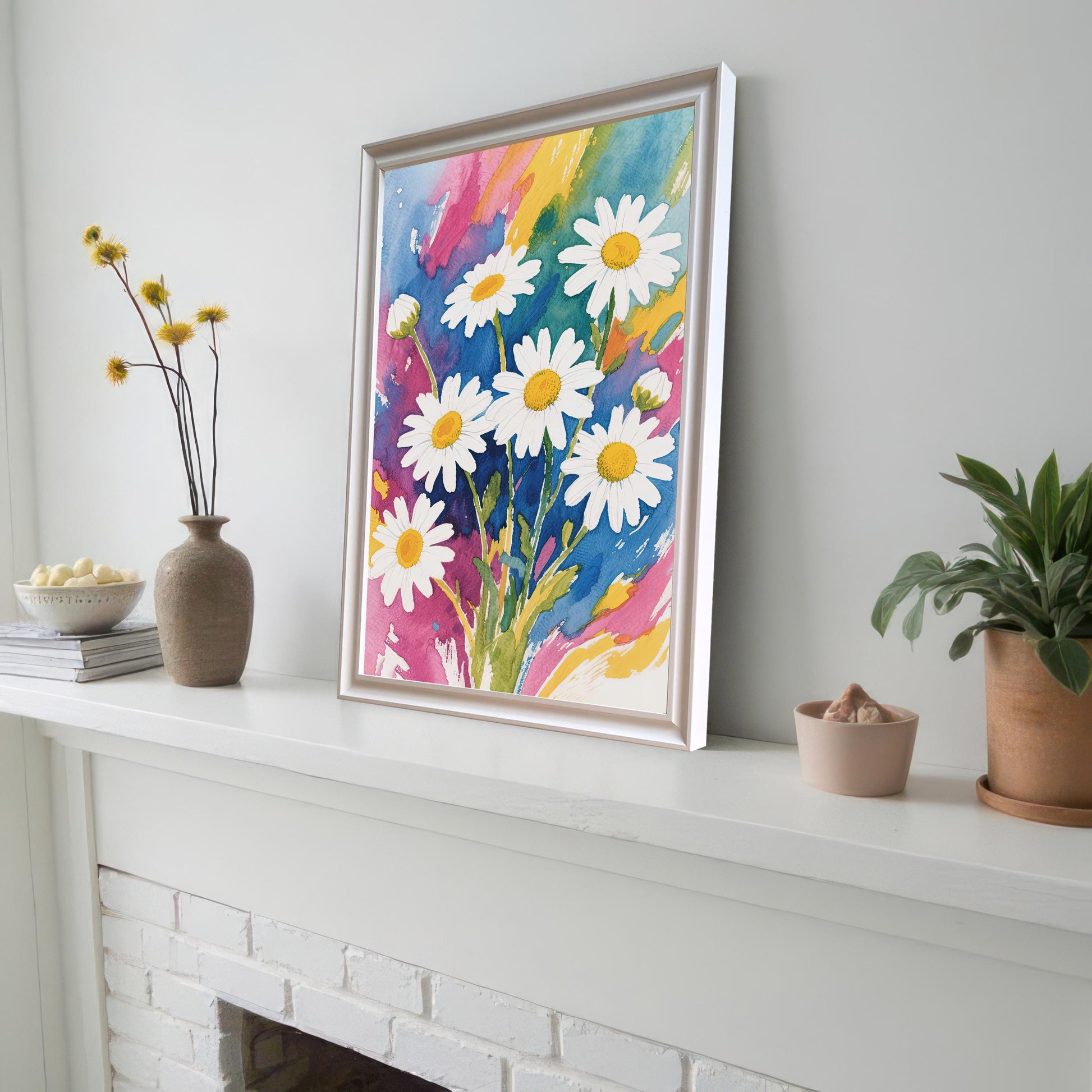 A framed watercolor print with a white frame propped on a white fireplace mantelpiece next to a couple of vases and a potted plant.