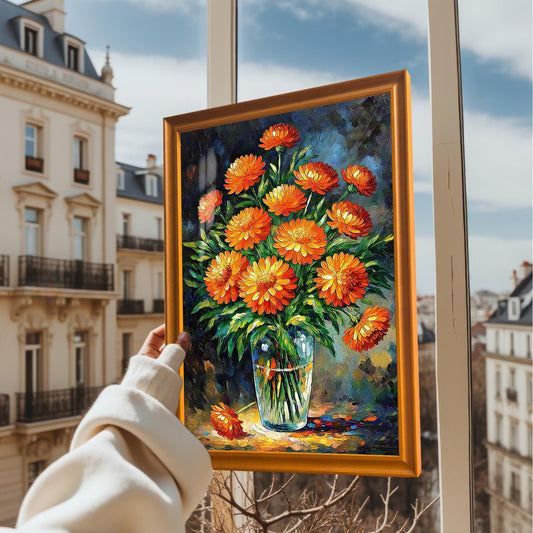 A hand holds up a framed art print of orange flowers against the backdrop of a building and a cloudy sky.