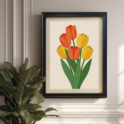 A black-framed art print of orange and yellow tulips hangs on a light wall above a plant in a pot.