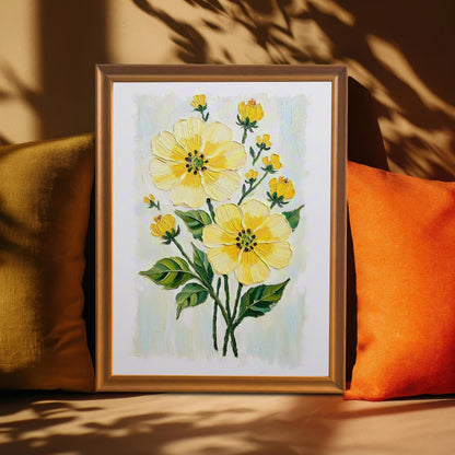 A framed, yellow floral print rests on a couch between a green and an orange pillow. Warm light and the shadow of a plant fall across the image.