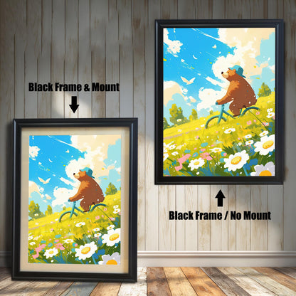 A split image featuring two versions of the art print framed in black. The left side shows a black-framed print with a cream-colored mat, and the right side shows the print in a black frame without a mat. The artwork shows a cheerful bear on a bike in a vibrant yellow field with white flowers.