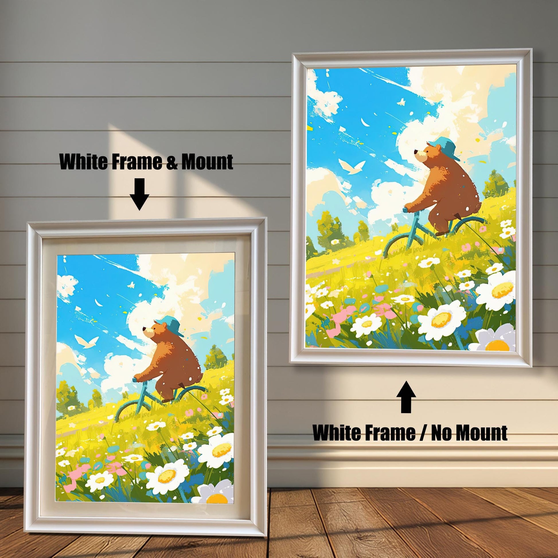 A split image showing two versions of a framed art print. The left side shows a white-framed print with a white mat, while the right shows the same print in a white frame without a mat. The art depicts a happy bear in a blue hat riding a bicycle through a field of yellow flowers under a sunny, blue sky. This image showcases two different white-frame styles.
