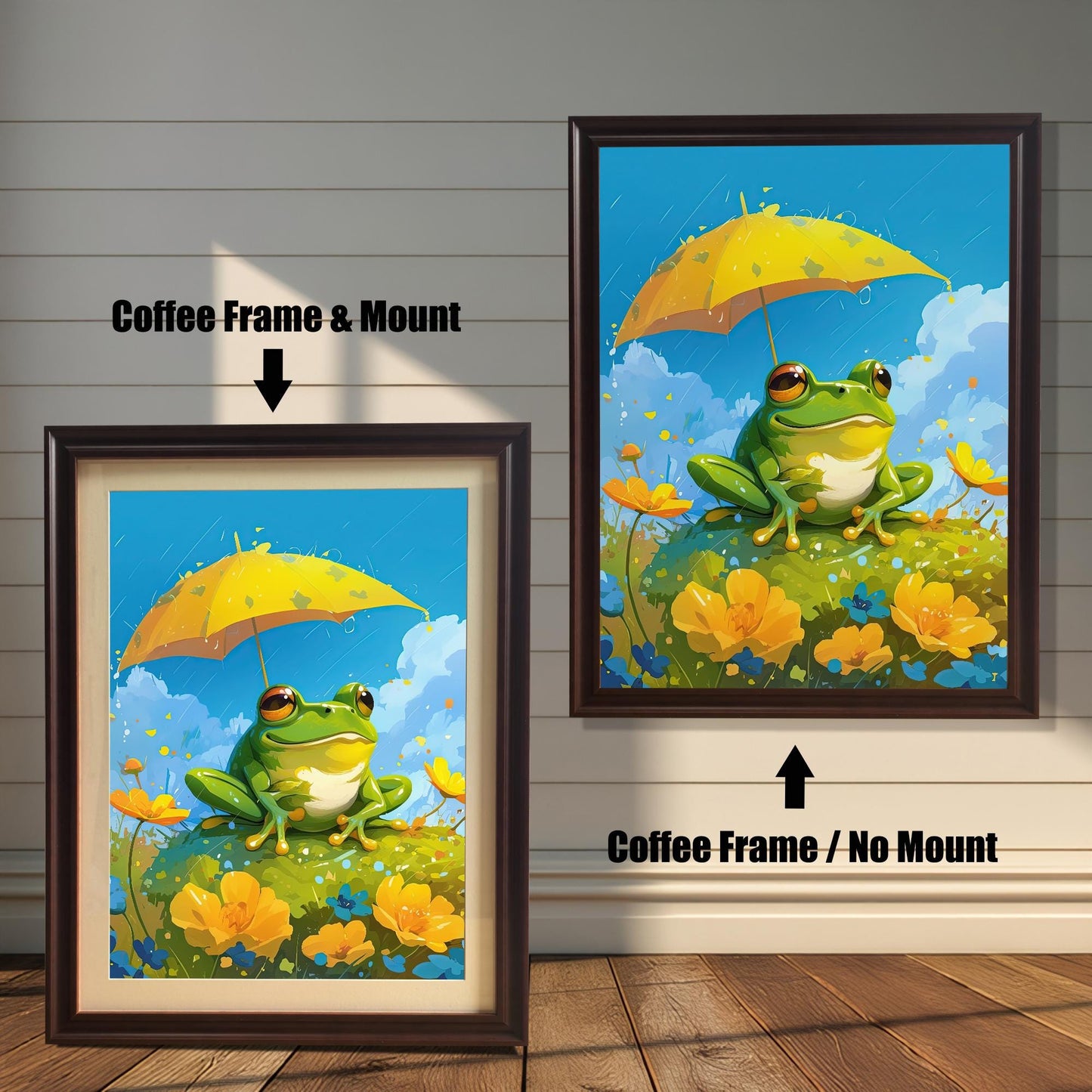 Two coffee-colored dark brown wood-framed art prints, showing a cute frog with a yellow umbrella. The print on the left has a white mat (mount), and the one on the right is a full-frame display. Both are shown against a white wood paneled wall.
