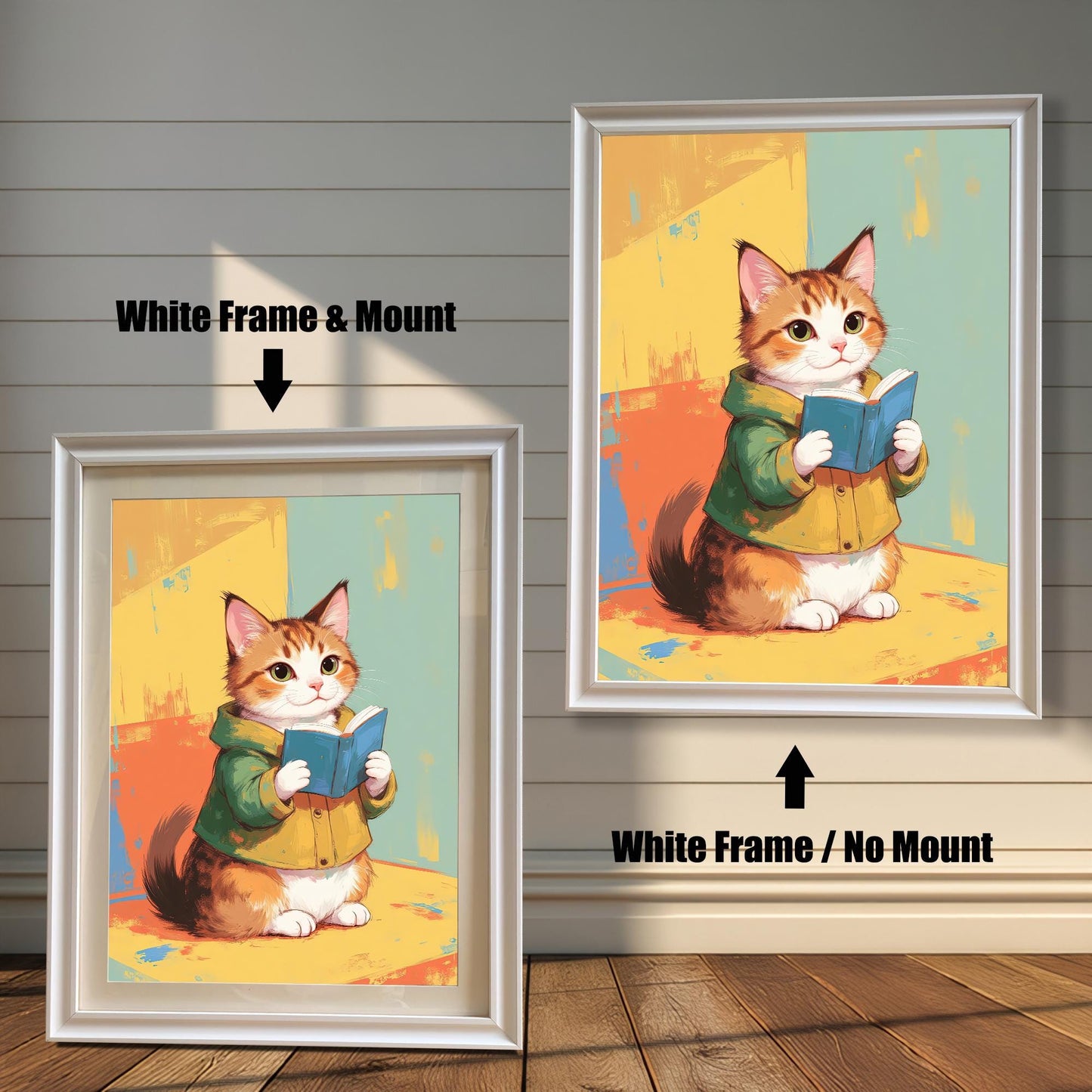 Two white-framed art prints of a cute cat reading a book. The print on the left has a white mat (mount) for a clean, classic look, while the one on the right is a full-frame display. Both pieces are leaning against a white wood paneled wall.