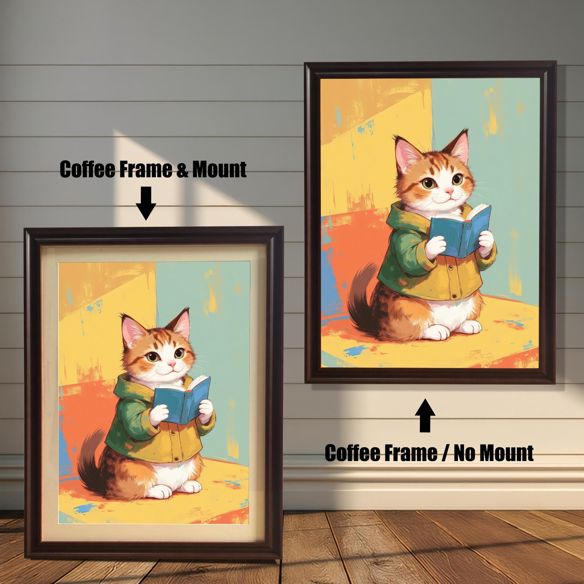 Two coffee-colored dark brown wood-framed art prints, showing a cute cat reading a book. The print on the left has a white mat (mount), and the one on the right is a full-frame display. Both are shown against a white wood paneled wall.