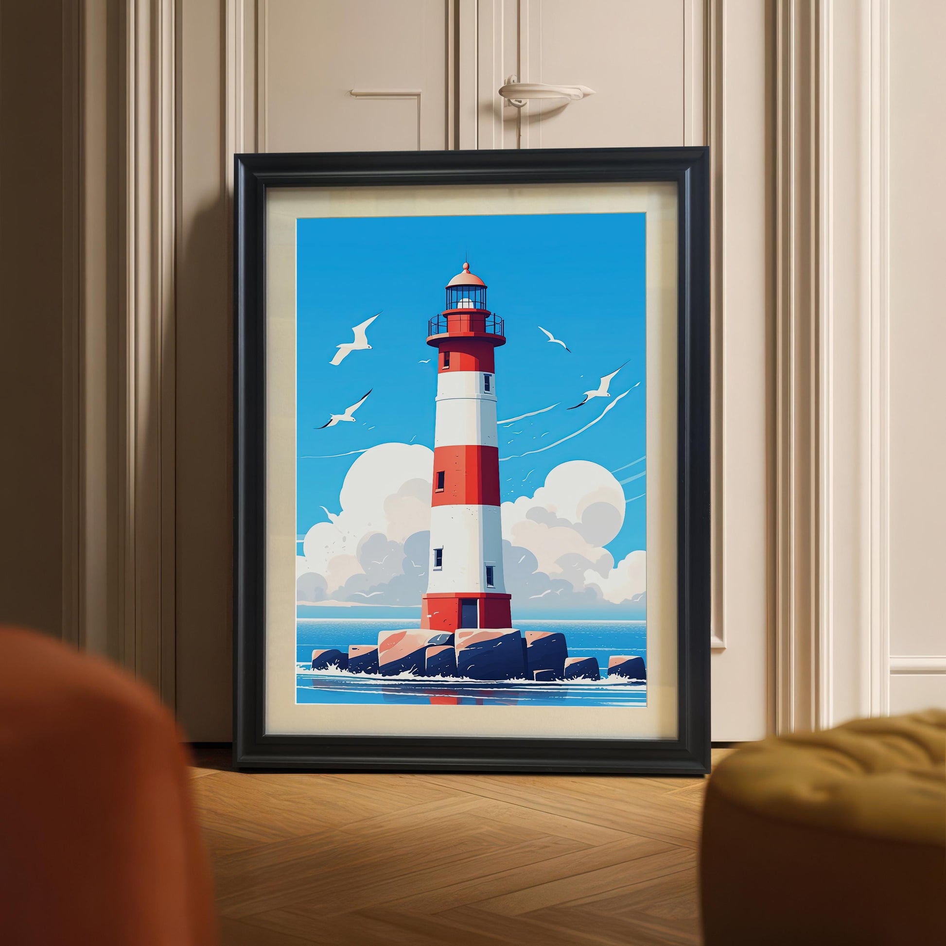A framed print of a red and white lighthouse with a black frame, leaning on the floor against a white paneled door. A gold-yellow cushioned ottoman is in the foreground.