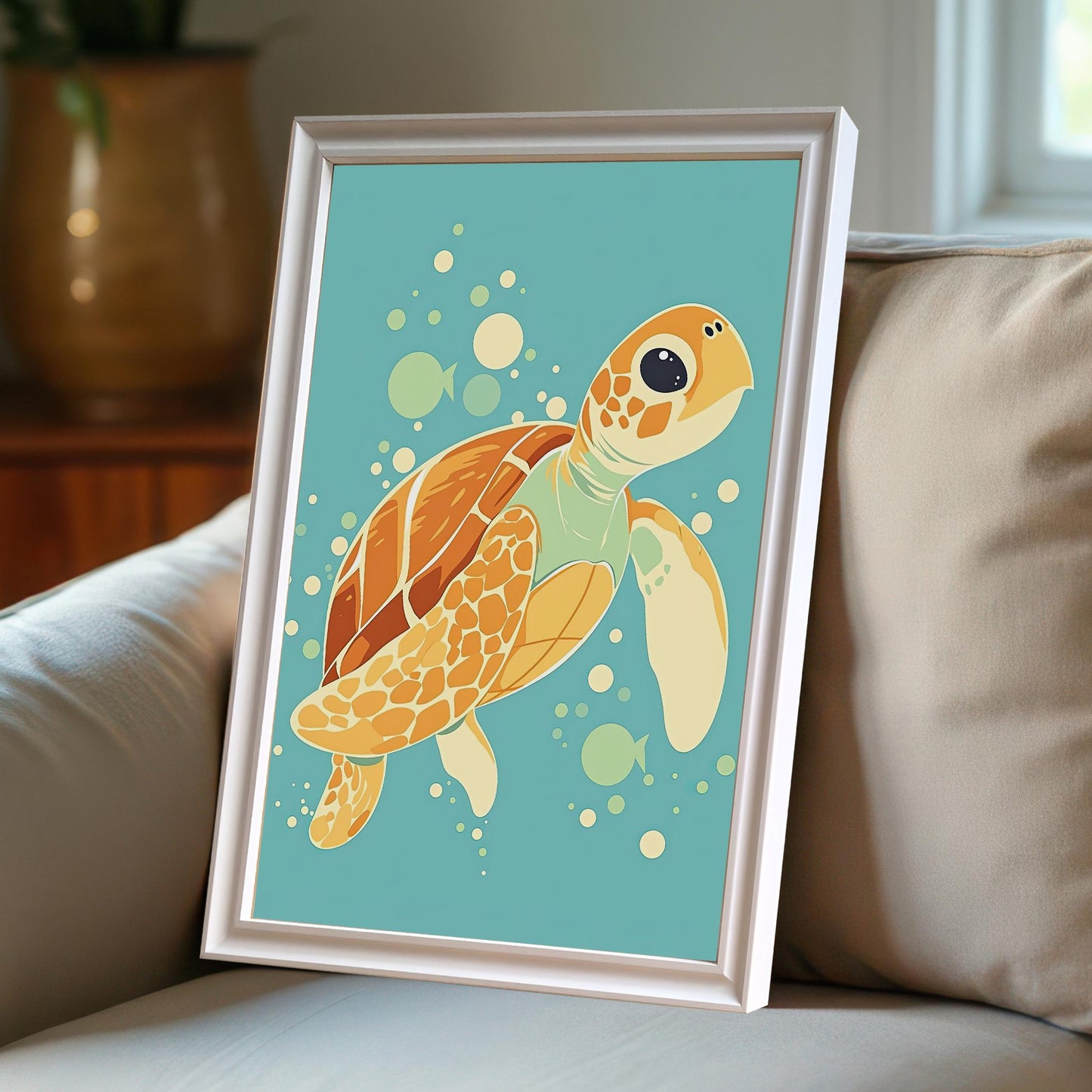 A white-framed print of a sea turtle is leaning against throw pillows on a couch.