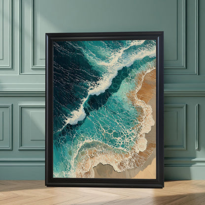 A large framed art print leans against a green paneled wall. The print shows an aerial view of waves crashing on a beach.