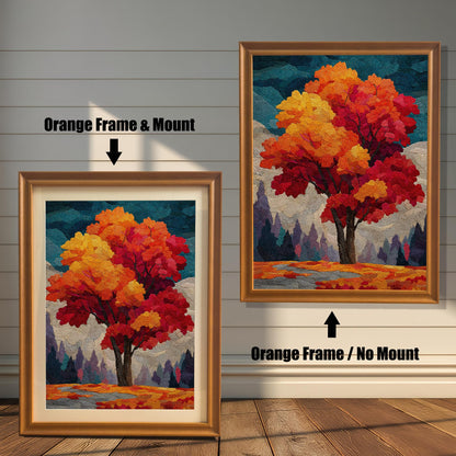 Two framed prints of an autumn tree stand on a wooden floor against a white paneled wall. The one on the left has an orange frame and a mount (mat), while the one on the right has an orange frame without a mount.