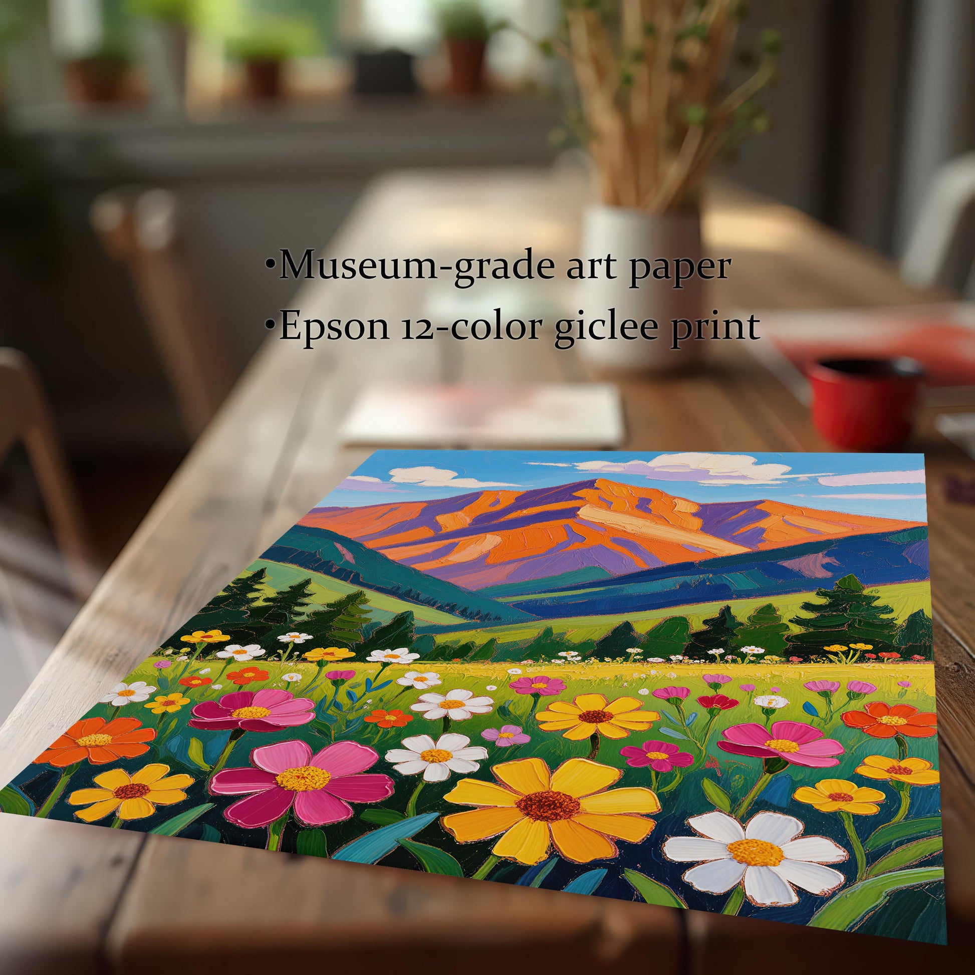 A close-up, angled view of a single art print of a mountain landscape on a wooden table, highlighting its museum-grade paper and giclée printing.