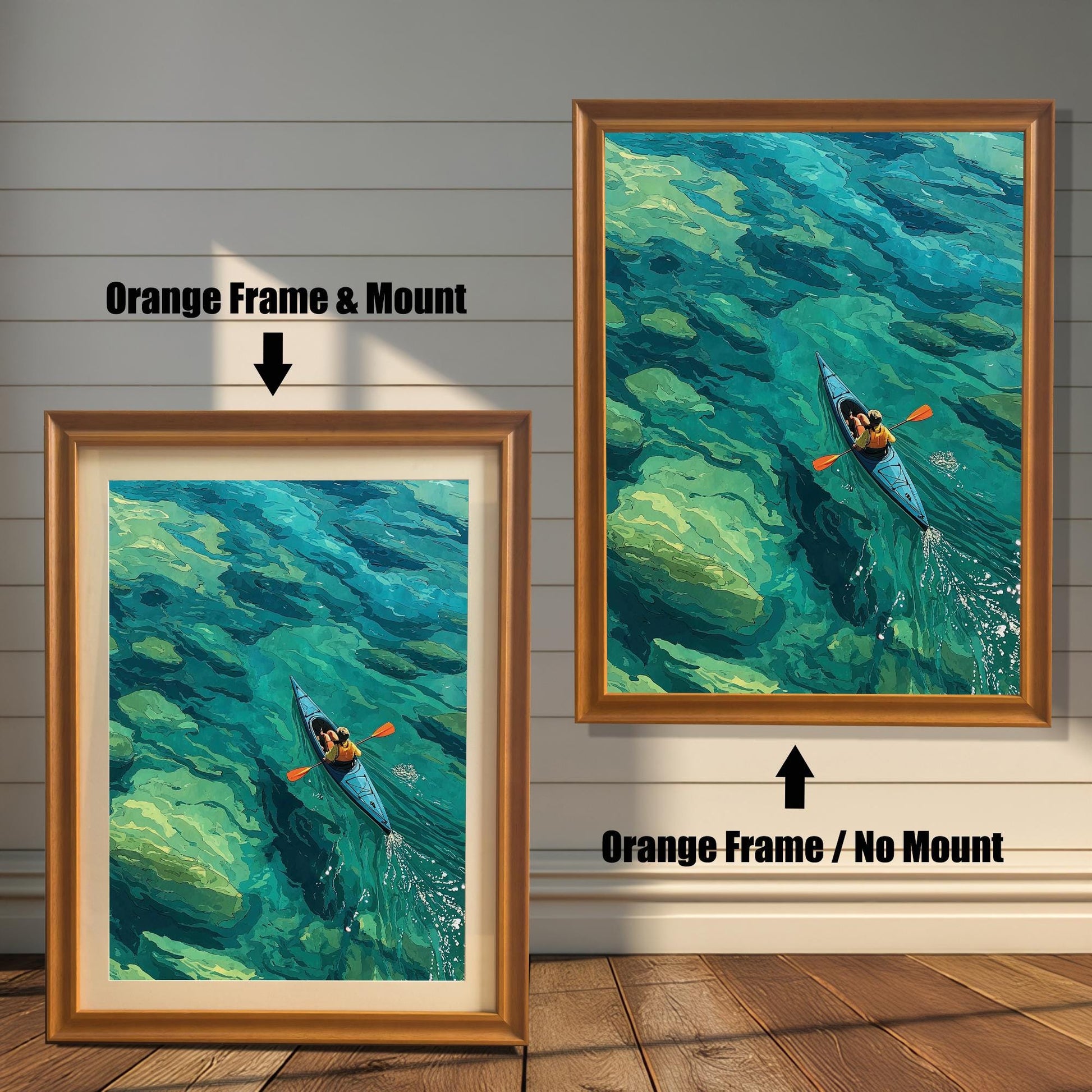 An orange-framed art print of a person in a kayak on turquoise water is displayed in two styles: with a mount (mat) on the left and without a mount on the right.