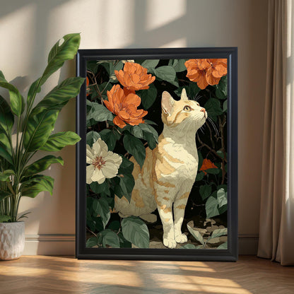 A framed wall art print of a cat among flowers, featuring a black frame, resting on a wooden floor against a beige wall next to a potted plant, with sun-lit curtains on the right.