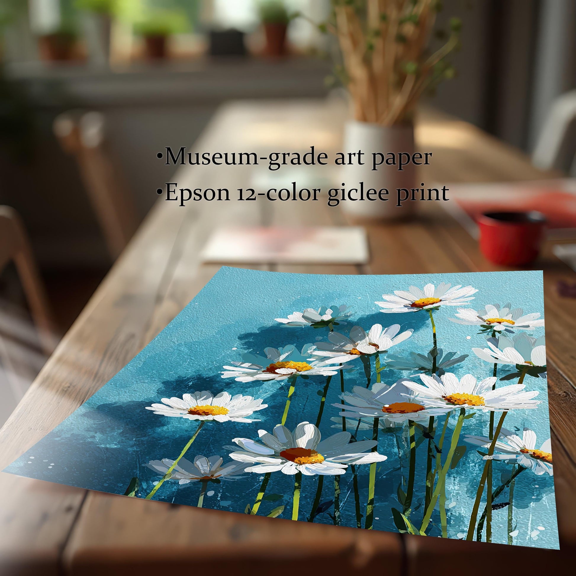 A flat art print of white daisies on a blue background on a wooden table, with text describing it as "museum-grade art paper" and an "Epson 12-color giclee print."