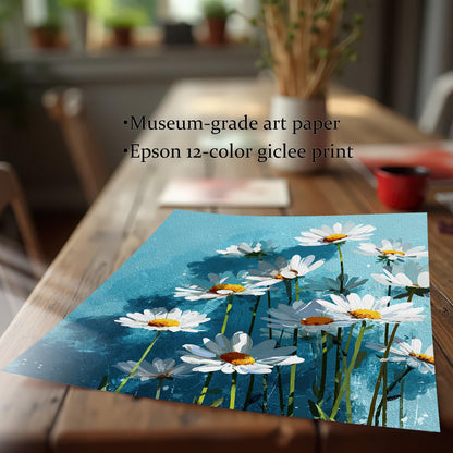 A flat art print of white daisies on a blue background on a wooden table, with text describing it as "museum-grade art paper" and an "Epson 12-color giclee print."