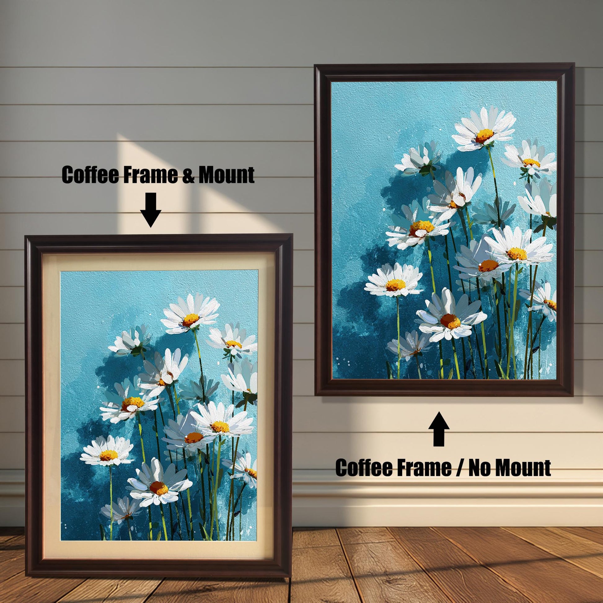 Two coffee-colored framed art prints of white daisies on a blue background. One has a white mat board and the other does not.