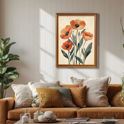 A framed art print of five orange poppies on a pale background, with a gold frame, hanging on a white wainscoting wall above a brown couch.