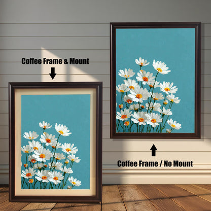 Two art prints of white daisies. The one on the left has a coffee-colored frame with a white mat. The one on the right has a coffee-colored frame with no mat.
