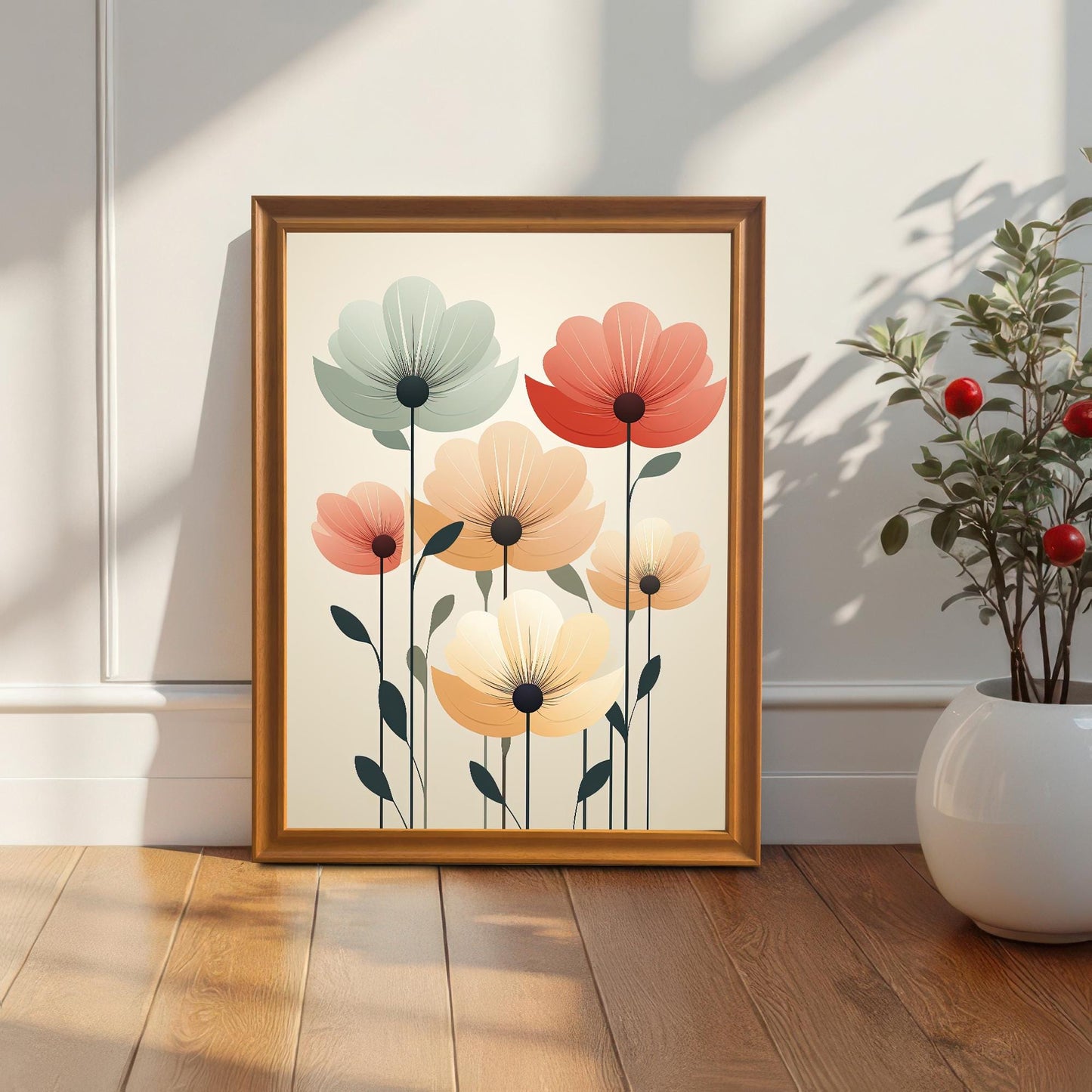 A single orange-colored, framed art print of abstract flowers leans against a white wall next to a potted plant on a wooden floor.