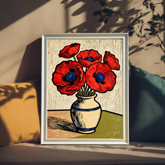 A framed art print of a vase of red poppies. The print is propped on a tan couch between a yellow pillow and a teal pillow, with sunlit shadows of leaves cast over the scene.