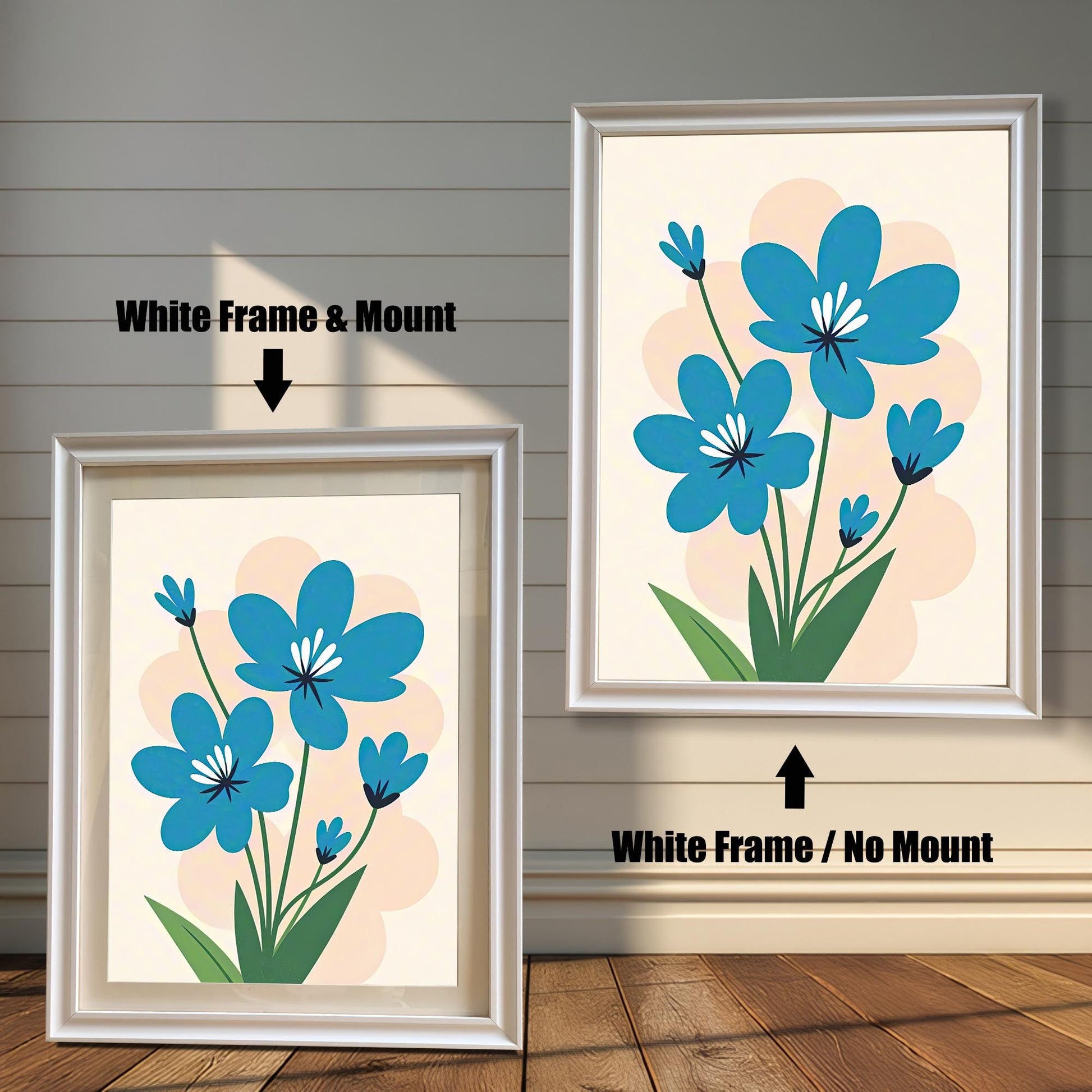 A side-by-side comparison of two white-framed prints of a blue flower painting. The print on the left is smaller with a mount (matting), while the larger one on the right has no mount.