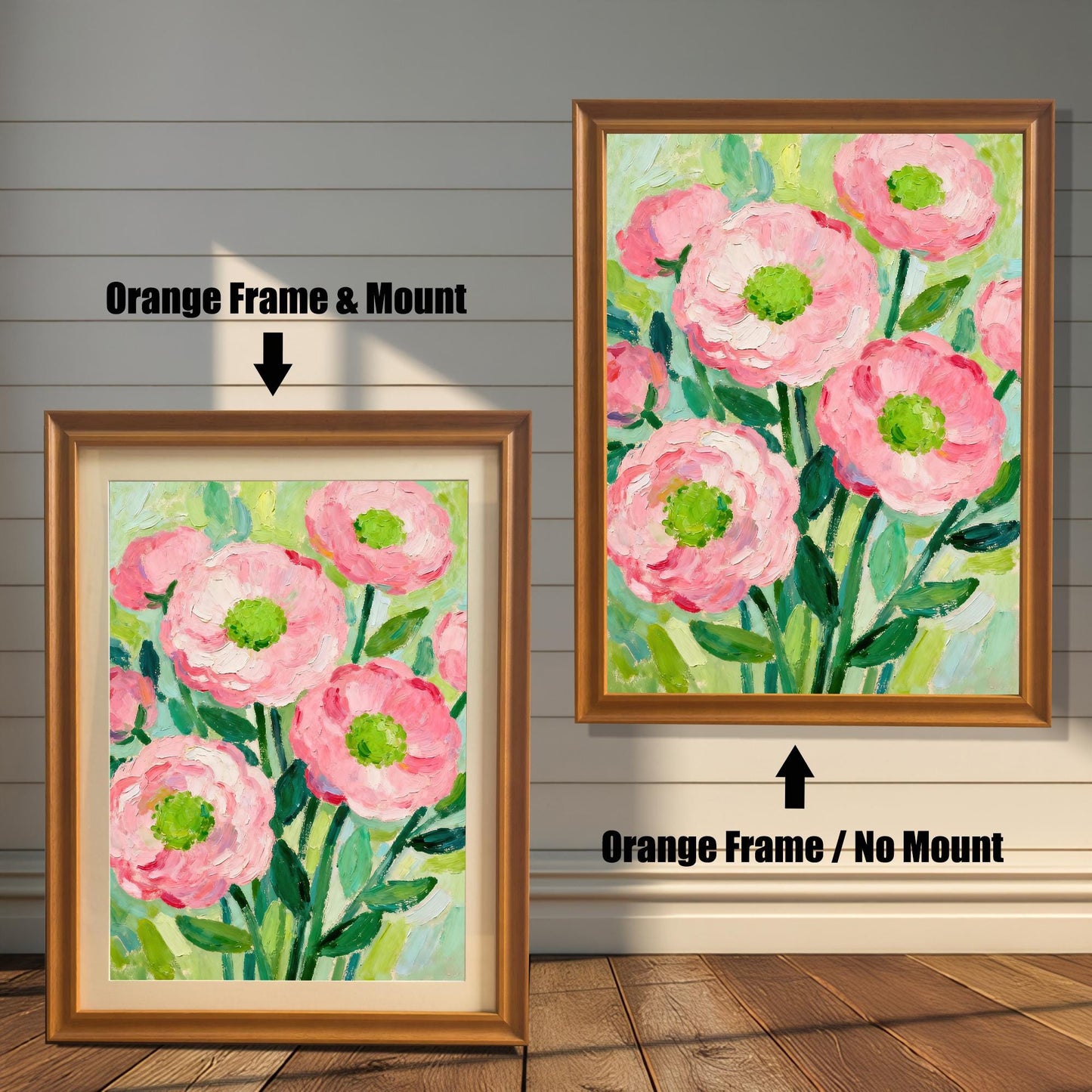 A painting of pink flowers in an orange frame, shown with and without a white mat, displayed against a rustic wood-paneled wall.