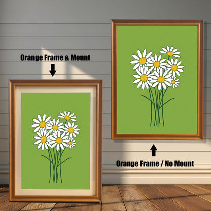 Two framed prints of a bunch of daisies on a green background. The left print has an orange frame with a mount, and the right has the same frame without a mount.