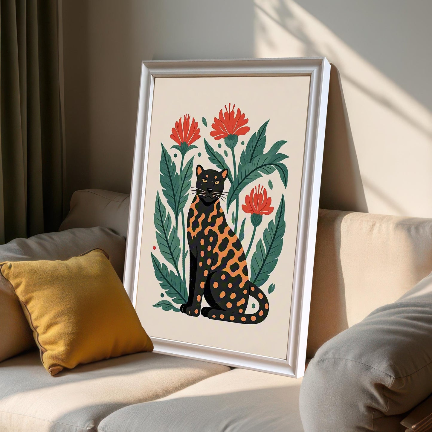 A framed print of a black and orange spotted leopard with red flowers, leaning on a light-colored couch with yellow pillows in a sunlit room.
