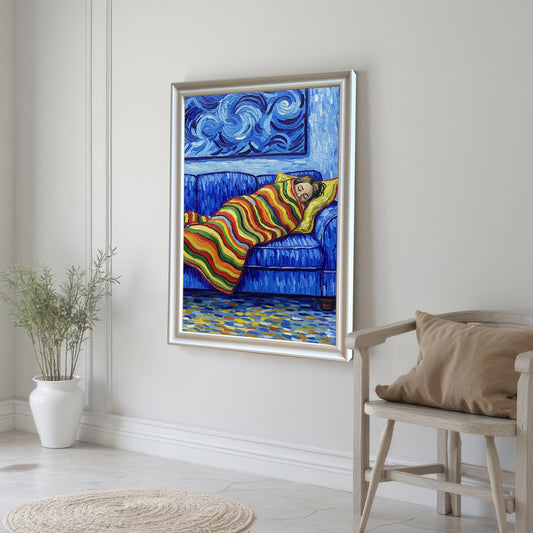 A painting of a person sleeping on a blue couch, framed in silver, hanging on a light gray wall. A light wood chair with a pillow sits below it.