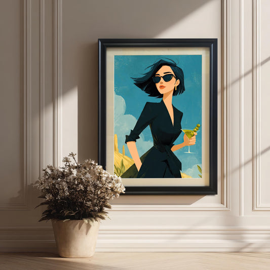 A black-framed art print of a stylish woman holding a martini, hanging on a white paneled wall with a plant in the foreground.
