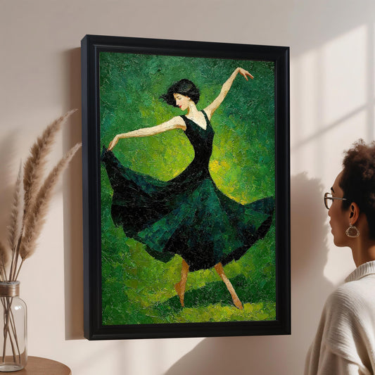A woman with glasses looks at a framed painting of a dancer in a dark green dress. The painting hangs on a light pink wall next to a glass vase with dried reeds.