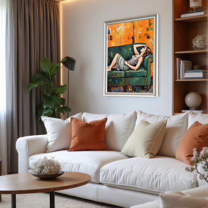 A framed painting with a silver-colored frame hangs on a gray wall in a modern living room with a white couch and a large plant.