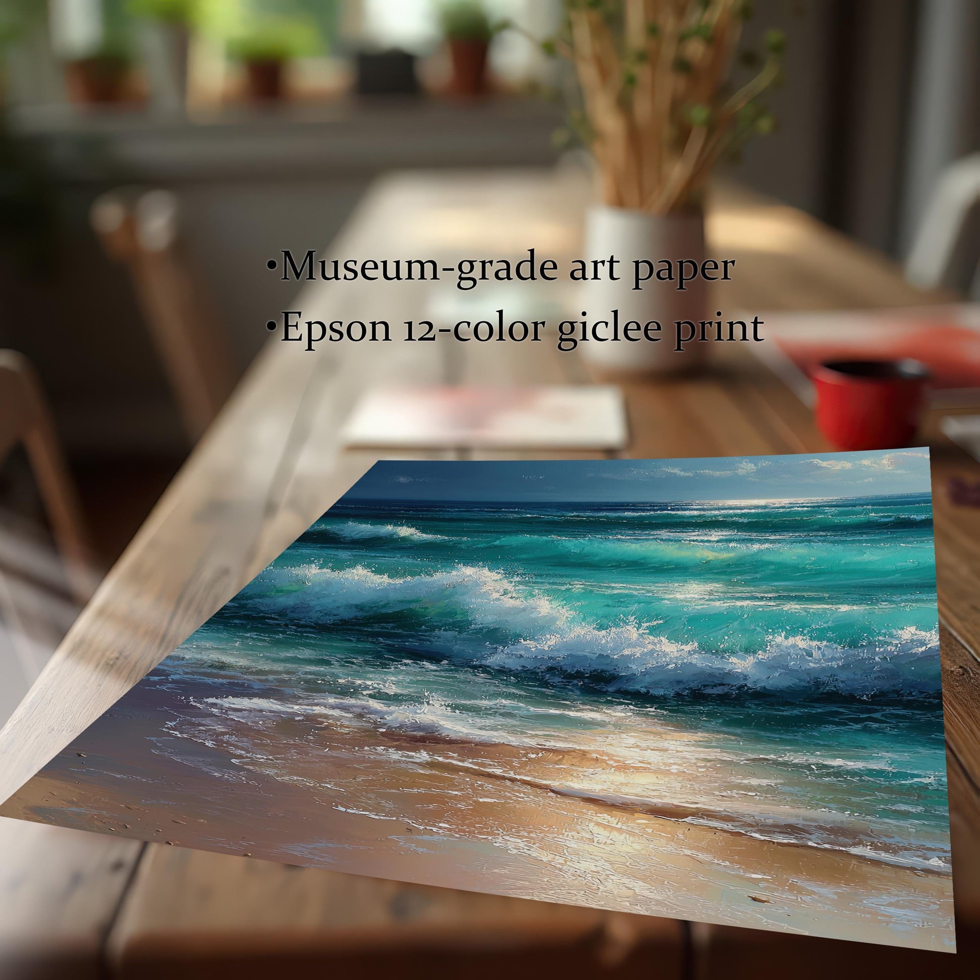 Close-up of a print showing turquoise ocean waves crashing on a sandy beach. It is lying on a wooden table. The text highlights "Museum-grade art paper" and "Epson 12-color giclee print."