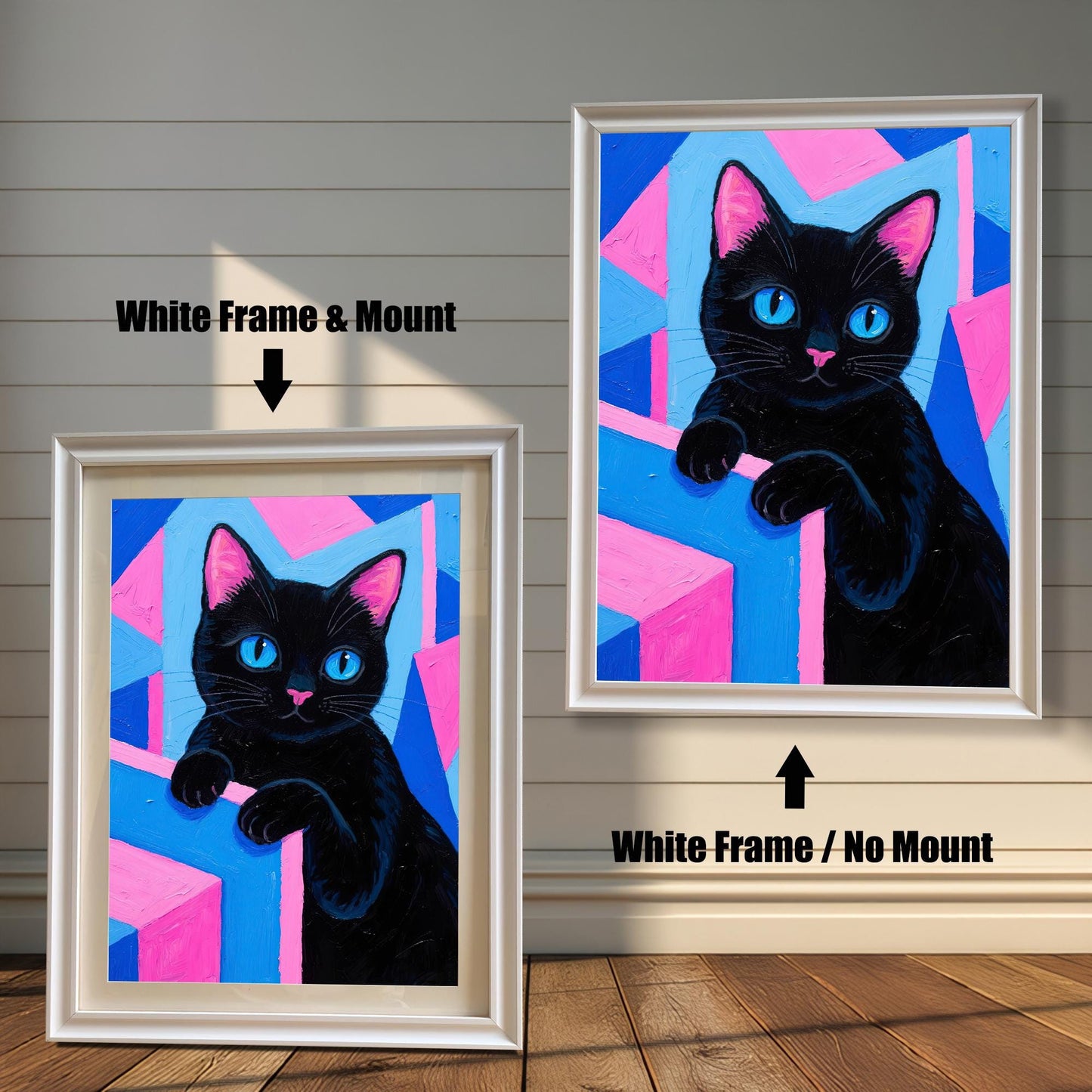 Two framed art prints of a black cat with blue eyes on a pink and blue background. One has a **White Frame & Mount**, the other a **White Frame / No Mount**.