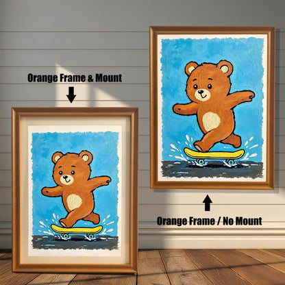 Side-by-side comparison of a teddy bear skateboarding print on a blue background, shown in a light brown **Orange Frame** with a white **Mount** (left) and without a mount (right).