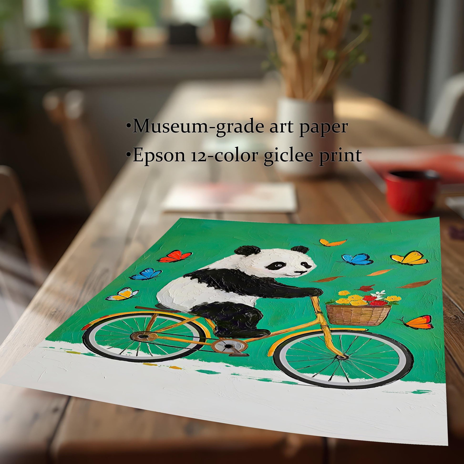 Close-up of an unframed art print of a panda on a bike, highlighting "Museum-grade art paper" and "Epson 12-color giclee print" as features.