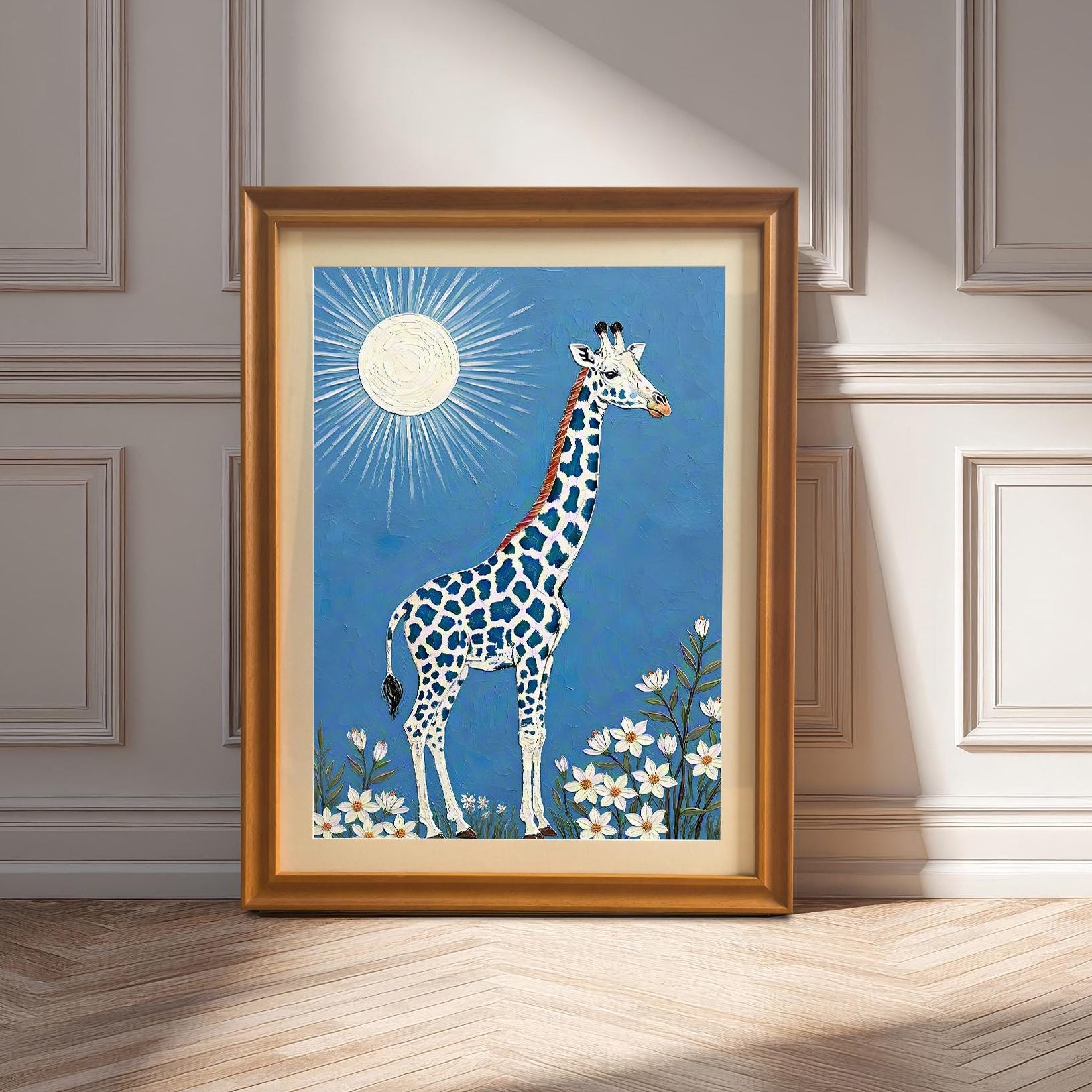 A framed giraffe print in an **Orange Frame & Mount** leans against a pale wall with decorative wainscoting, illuminated by a sunlit herringbone wood floor.