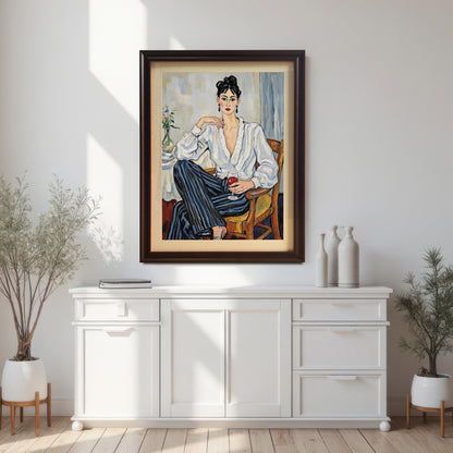 A framed art print of a woman holding a glass of wine hanging above a white console table. The frame is a dark brown or coffee color.