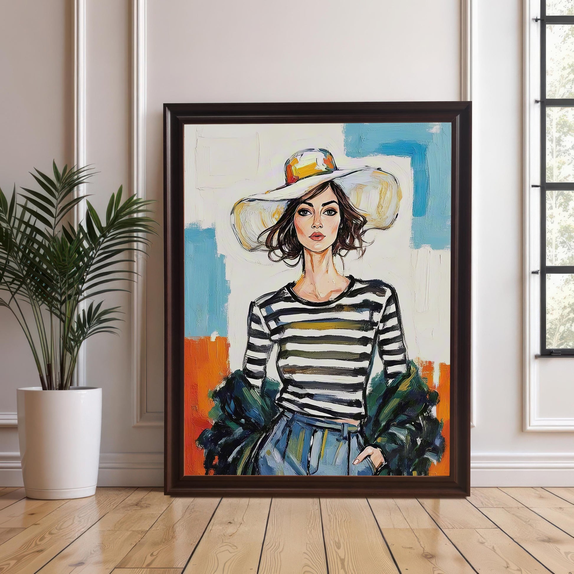 A framed art print of a woman in a striped shirt and hat leaning against a wall next to a houseplant. The frame is a dark brown or coffee color.