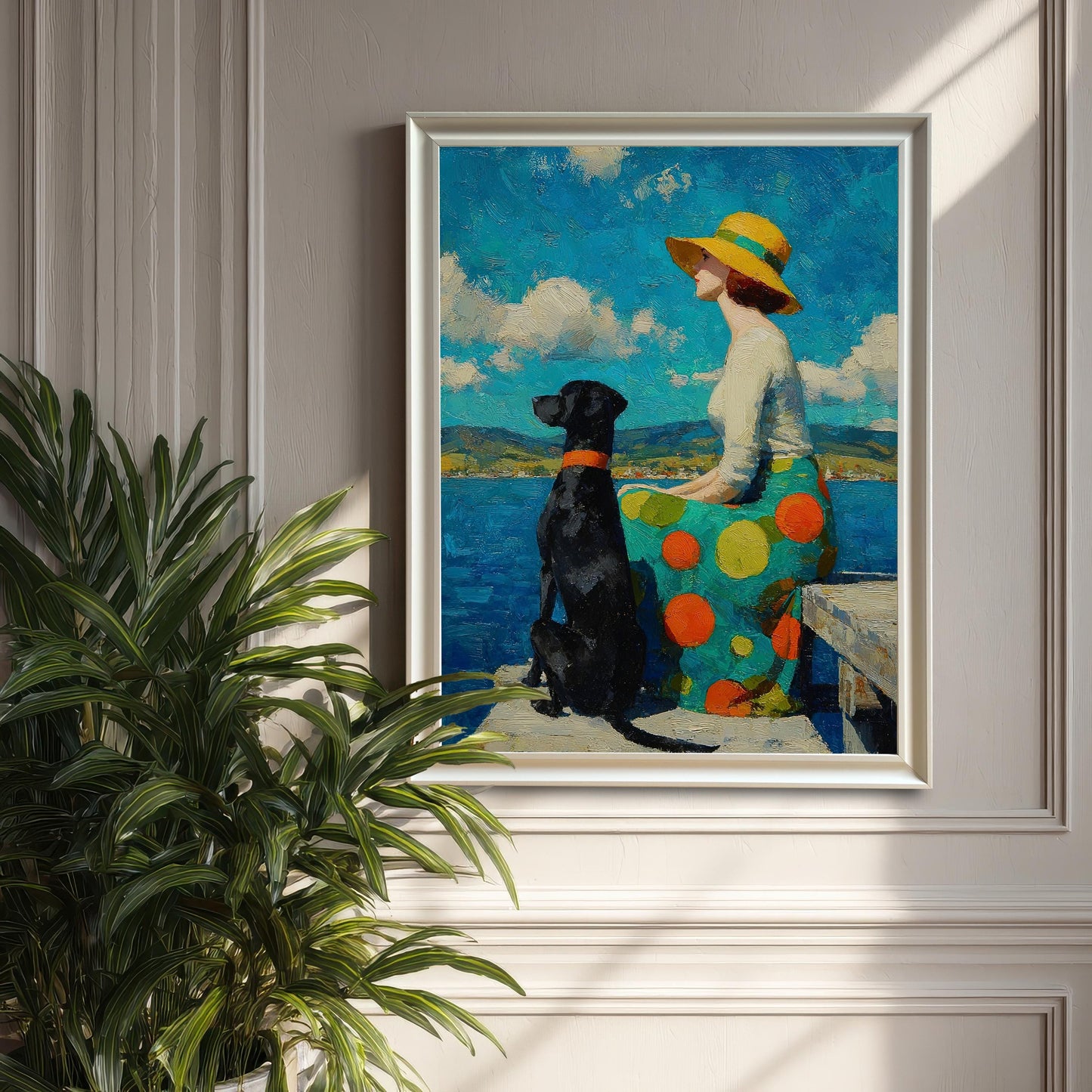 A framed painting of a woman in a wide-brimmed hat and a dog sitting on a dock by the water, hung on a textured wall next to a houseplant.
