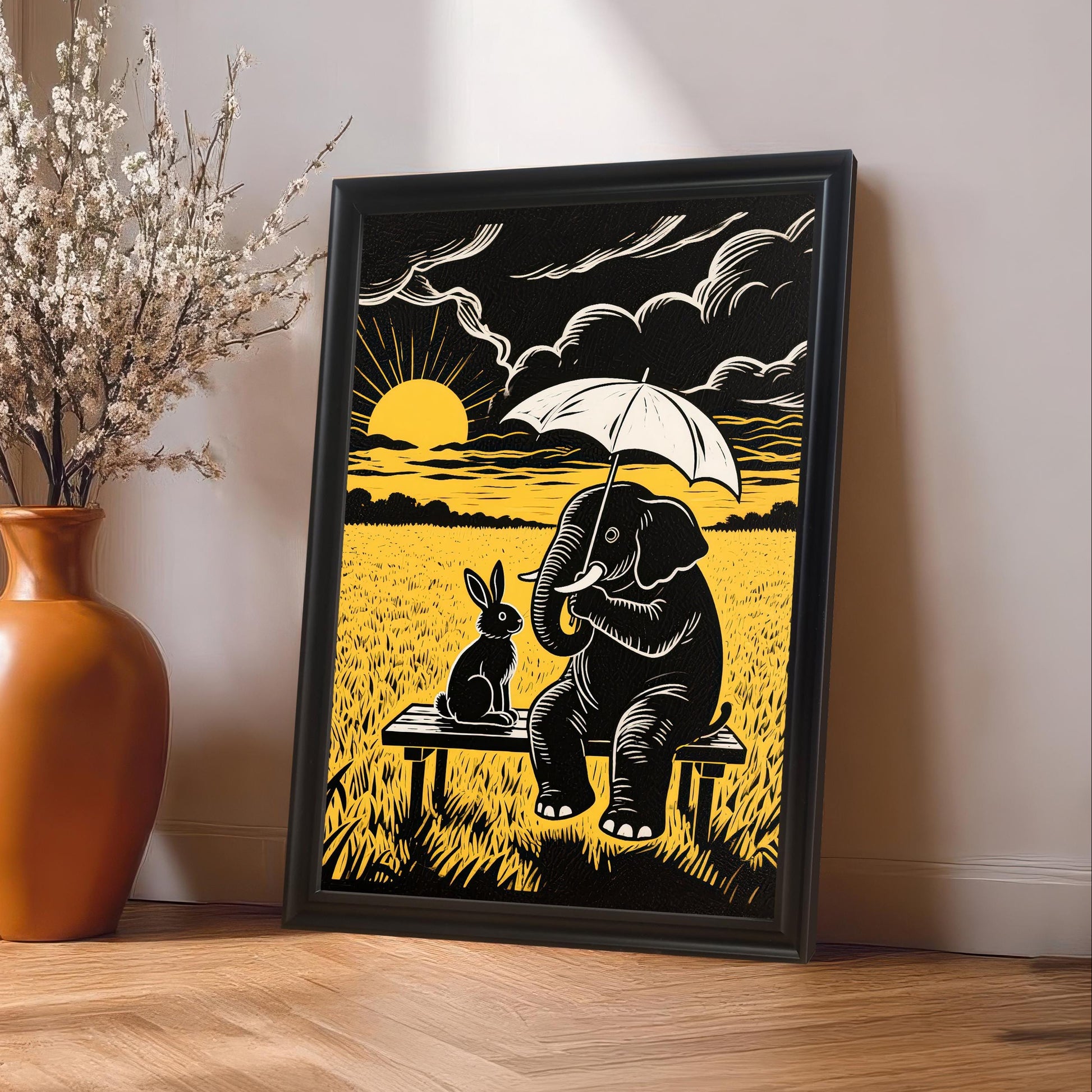 A black and yellow elephant and rabbit print in a Black Frame leans against a white wall next to an orange vase with white flowers on a wooden floor.