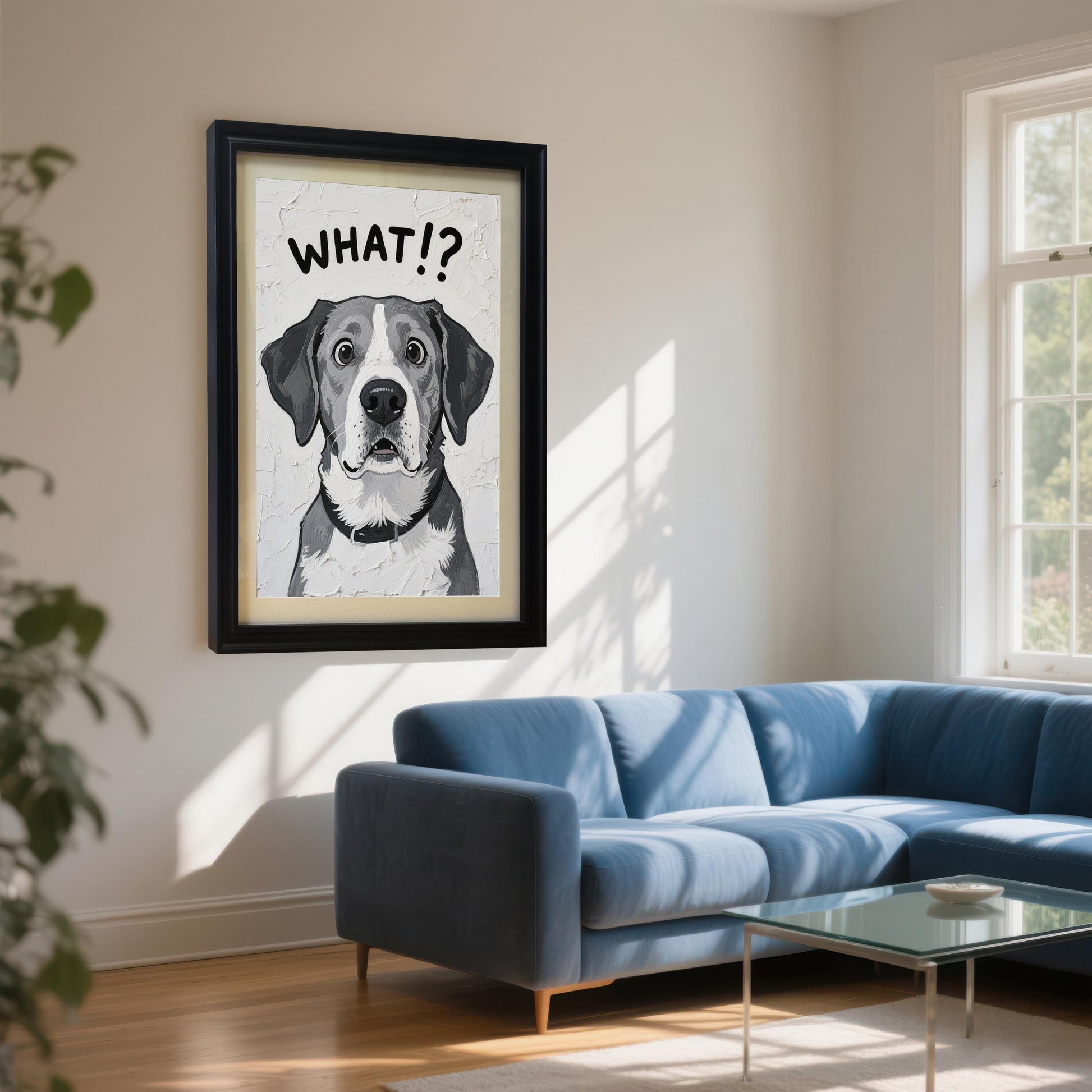 A black-framed painting of a dog with "WHAT!?" written above it, hanging on a white wall above a blue sectional sofa.