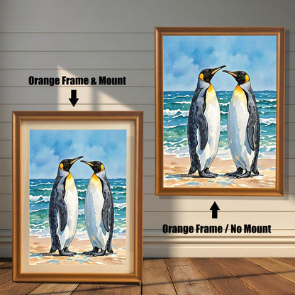 Watercolor penguin art in two orange frames: "Orange Frame & Mount" (with mat) and "Orange Frame / No Mount" (no mat), against a white paneled wall.